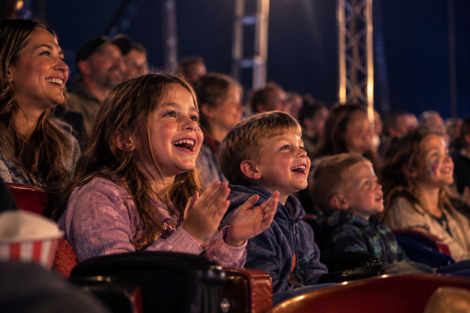 Familie: strahlende Kinder im Circus-Publikum